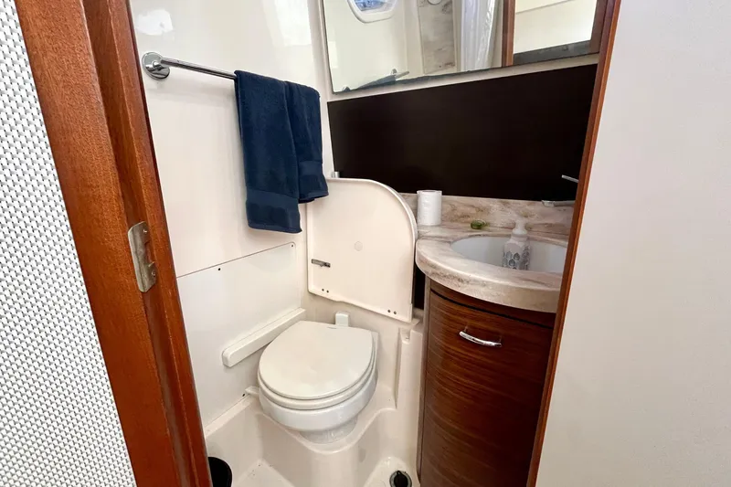 Perseverance Yacht Photos Pics 2019 Pursuit S 368 Sport boat bathroom with toilet, sink, and towels.