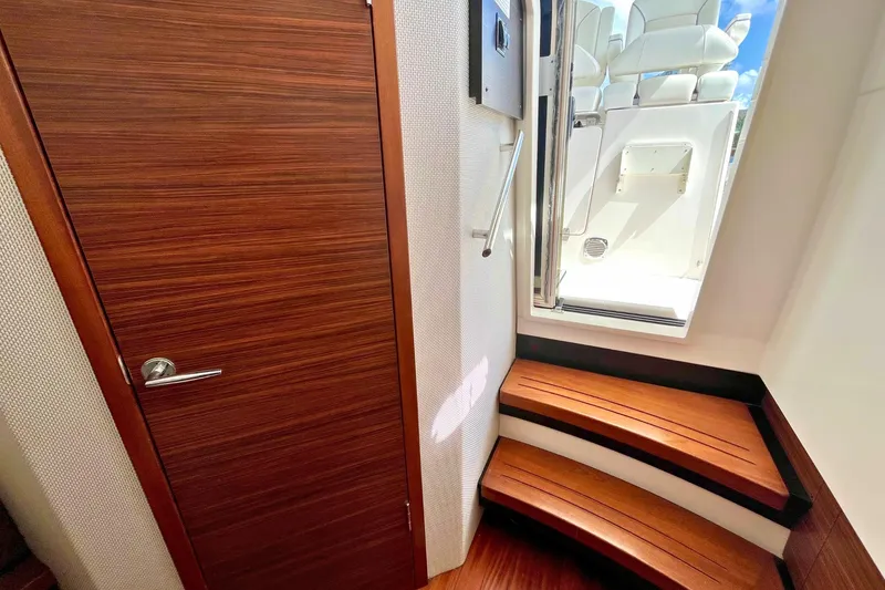 Perseverance Yacht Photos Pics Interior of 2019 Pursuit S 368 Sport boat with wooden steps and door.