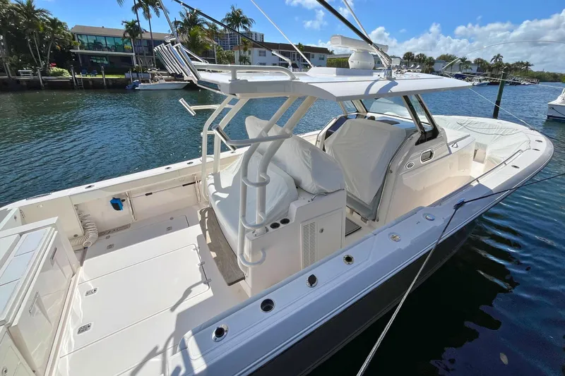Perseverance Yacht Photos Pics 2019 Pursuit S 368 Sport boat docked, featuring spacious deck and modern design.