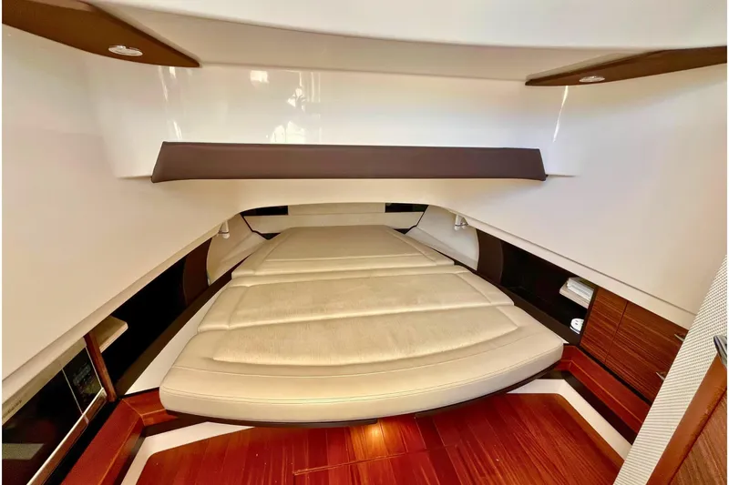 Perseverance Yacht Photos Pics 2019 Pursuit S 368 Sport cabin interior with elegant wood finish and comfortable bedding.