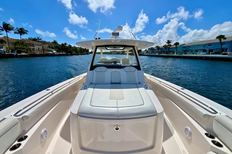 Perseverance Yacht Photos Pics 2019 Pursuit S 368 Sport boat on a sunny waterfront, showcasing luxury seating and sleek design.
