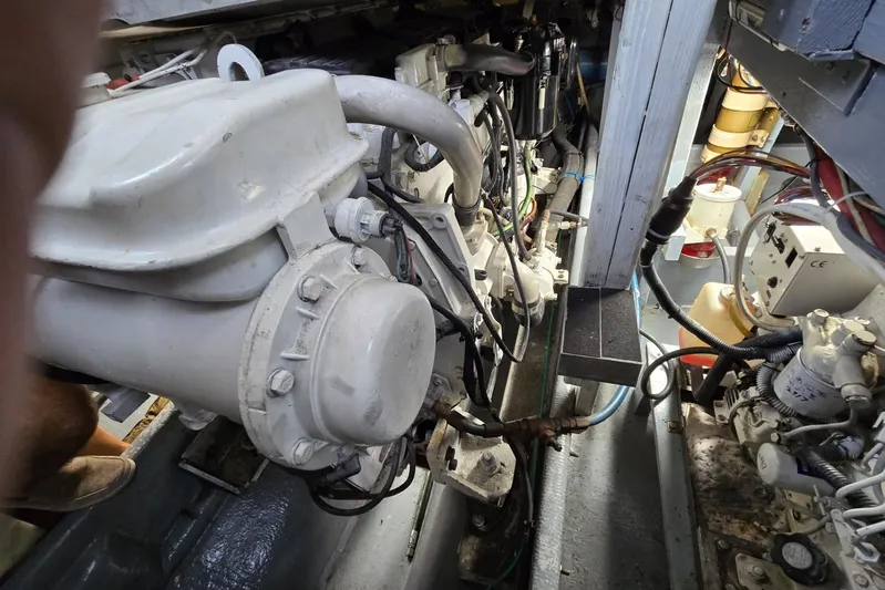 Sunrise Yacht Photos Pics Engine compartment of a 1995 MDI Downeast boat, showcasing mechanical components and wiring.