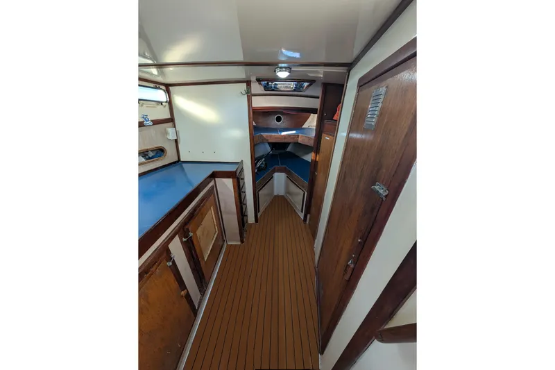 Sunrise Yacht Photos Pics Interior of a 1995 MDI Downeast boat with wooden cabinetry and flooring.