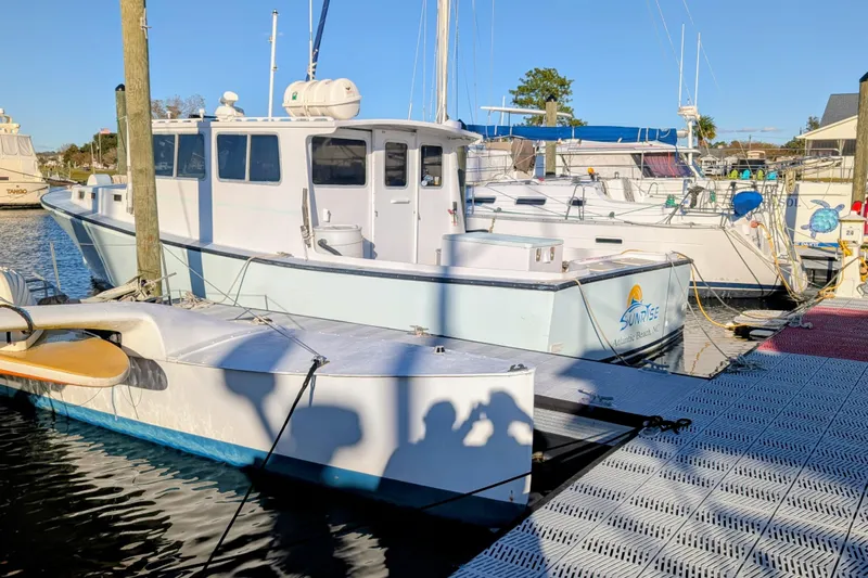 Sunrise Yacht Photos Pics Docked 1995 MDI Downeast boat at marina under clear blue sky.
