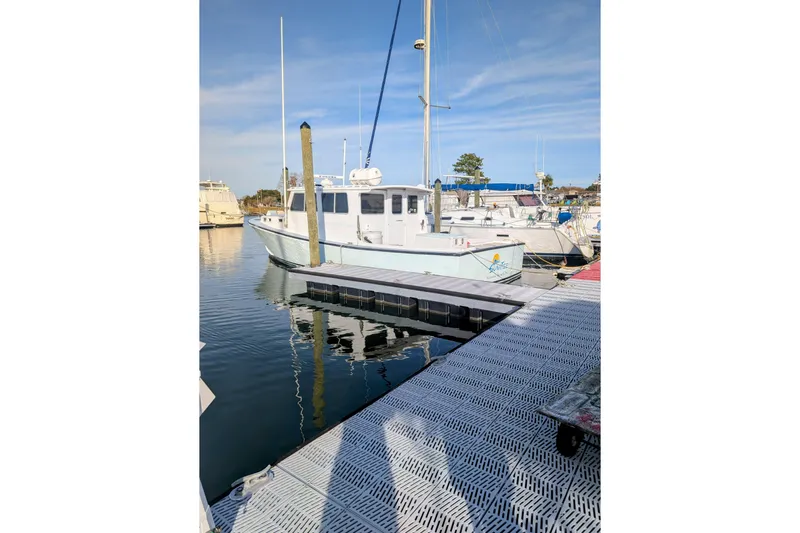 Sunrise Yacht Photos Pics 1995 MDI Downeast boat docked at marina under clear blue sky.
