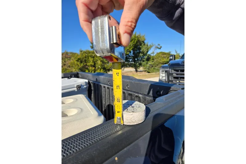 Sunrise Yacht Photos Pics Hand measuring object with tape measure on truck bed, MDI Downeast 1995 model.