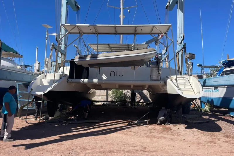  Yacht Photos Pics 1998 Voyage Norseman 430 catamaran in dry dock, undergoing maintenance under clear blue sky.
