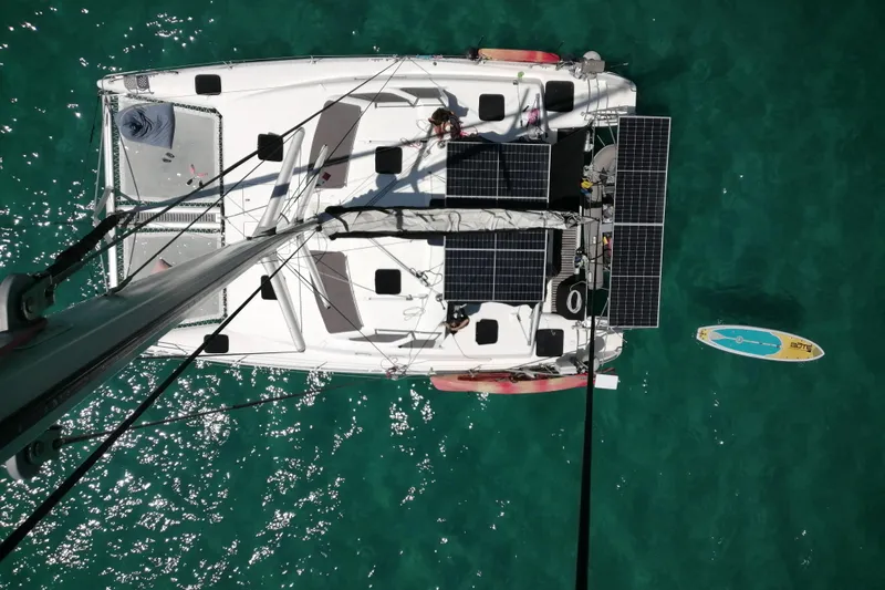  Yacht Photos Pics Aerial view of 1998 Voyager Norseman 430 catamaran with solar panels on turquoise water.