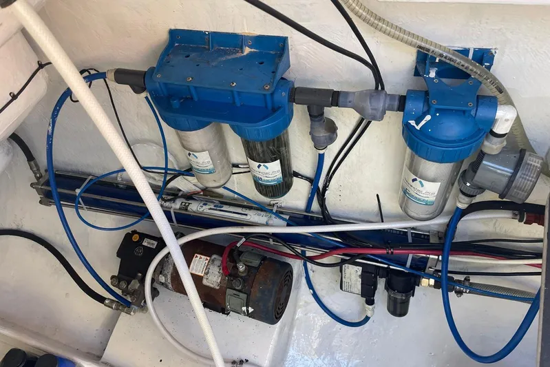  Yacht Photos Pics Water filtration system in a 1998 Voyager Norseman 430 boat, featuring blue filters and tubing.