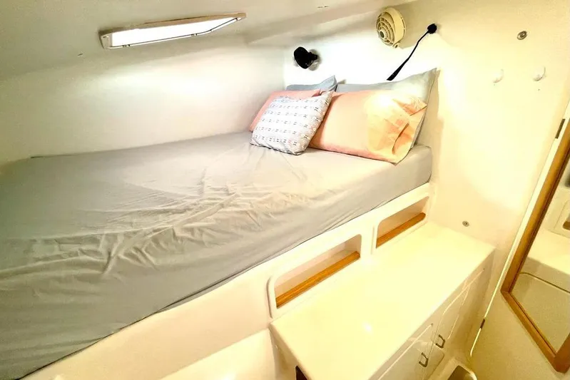  Yacht Photos Pics Cozy cabin interior of 1998 Voyager Norseman 430 with bed and storage.