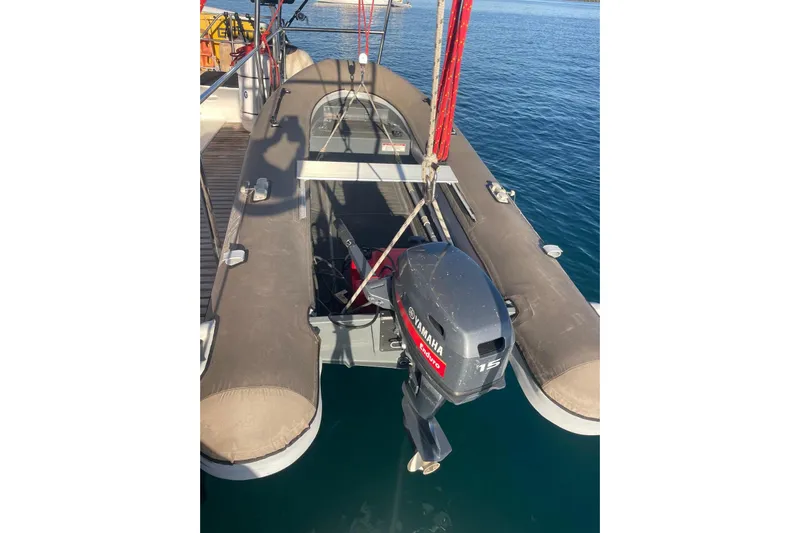  Yacht Photos Pics Voyager Norseman 430 inflatable boat with Yamaha outboard motor, docked on calm water.