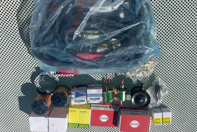  Yacht Photos Pics Assorted mechanical parts and filters for Voyager Norseman 430, 1998 model, on perforated surface.