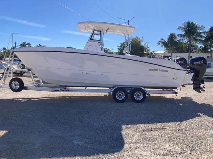  Yacht Photos Pics 2025 Twin Vee 260STX boat on trailer, parked outdoors under clear sky.