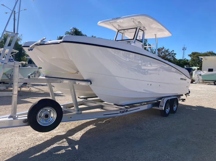  Yacht Photos Pics 2025 Twin Vee 260STX boat on trailer under clear blue sky.