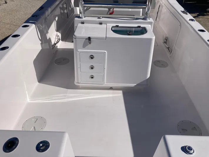  Yacht Photos Pics 2025 Twin Vee 260STX boat interior with storage compartments and seating.