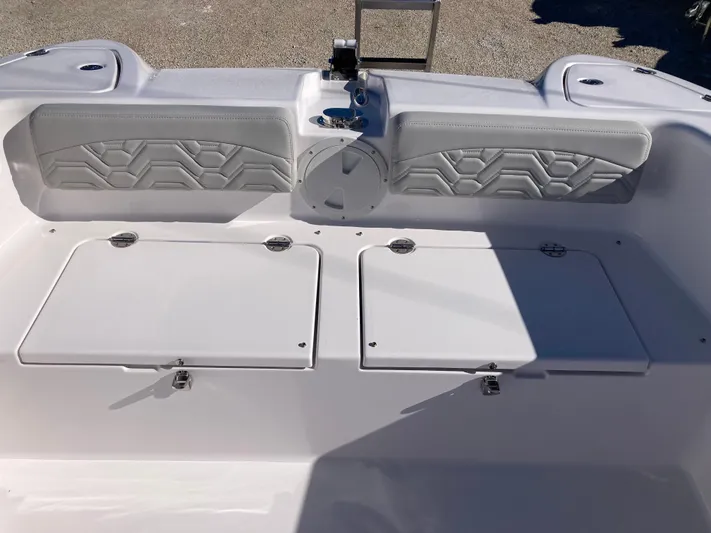  Yacht Photos Pics 2025 Twin Vee 260STX boat interior with storage compartments and cushioned seating.