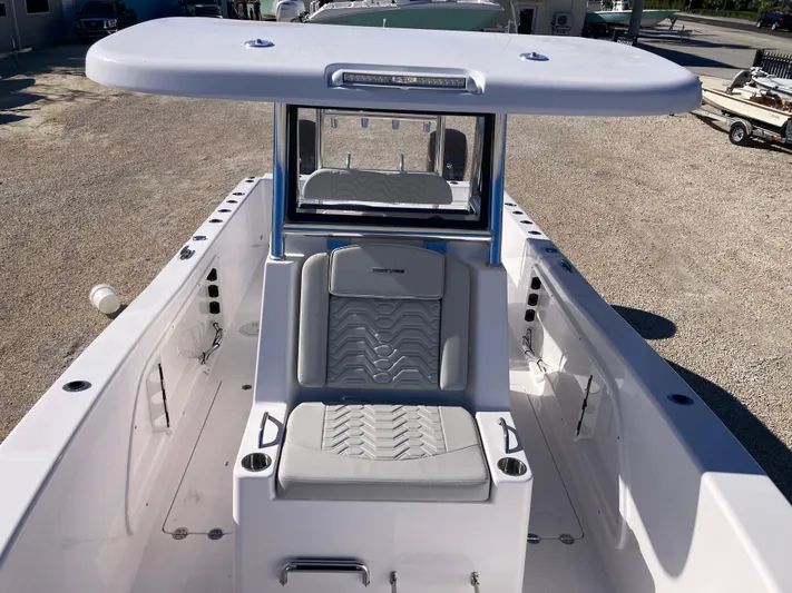  Yacht Photos Pics 2025 Twin Vee 260STX boat interior with cushioned seating and T-top.