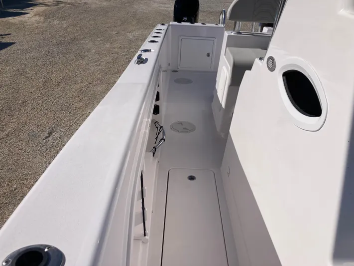  Yacht Photos Pics 2025 Twin Vee 260STX boat interior, featuring spacious deck and storage compartments.