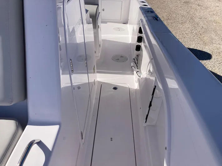  Yacht Photos Pics 2025 Twin Vee 260STX boat interior with sleek white deck and seating.