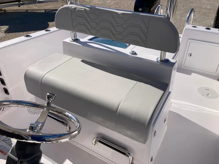  Yacht Photos Pics 2025 Twin Vee 260STX boat interior with cushioned seating and steering wheel.