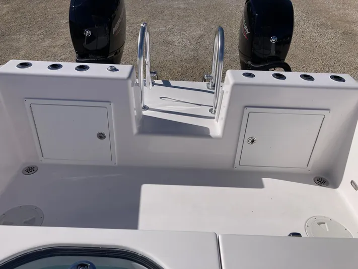  Yacht Photos Pics 2025 Twin Vee 260STX boat deck with storage compartments and dual engines.