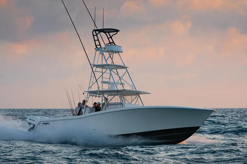  Yacht Photos Pics Manufacturer Provided Image: 2022 Invincible 42 Open Fisherman boat cruising on the ocean at sunset.