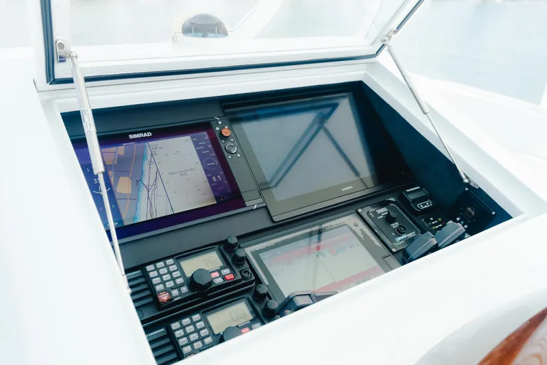 Sea Angel Yacht Photos Pics Control panel of a 1980 Scarborough 46 Convertible boat with navigation screens.