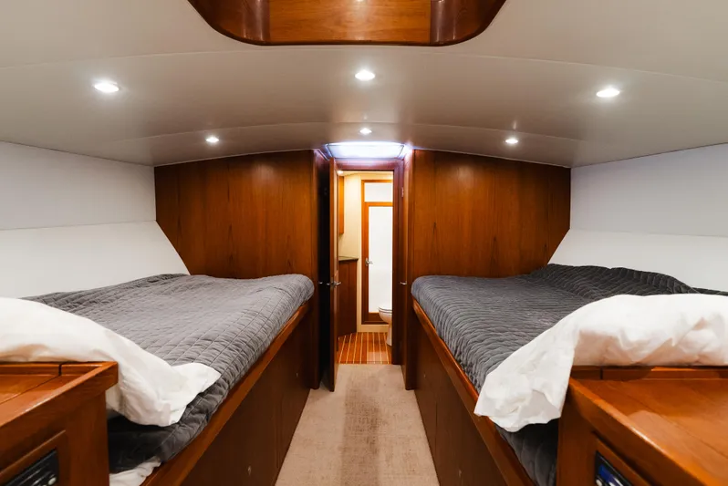 Sea Angel Yacht Photos Pics Interior of 1980 Scarborough 46 Convertible yacht with twin beds and wood paneling.