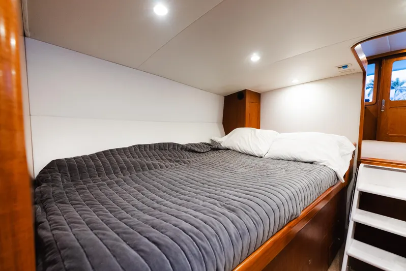 Sea Angel Yacht Photos Pics Cozy cabin interior of 1980 Scarborough 46 Convertible yacht with comfortable bedding.