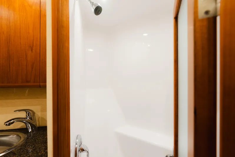 Sea Angel Yacht Photos Pics Shower area in 1980 Scarborough 46 Convertible yacht with wooden accents and modern fixtures.