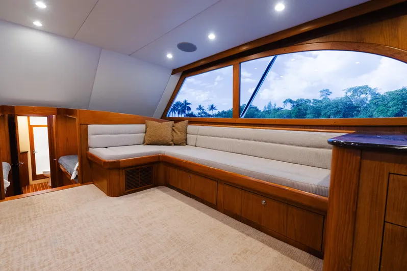 Sea Angel Yacht Photos Pics Luxurious interior of 1980 Scarborough 46 Convertible yacht with plush seating and scenic window view.