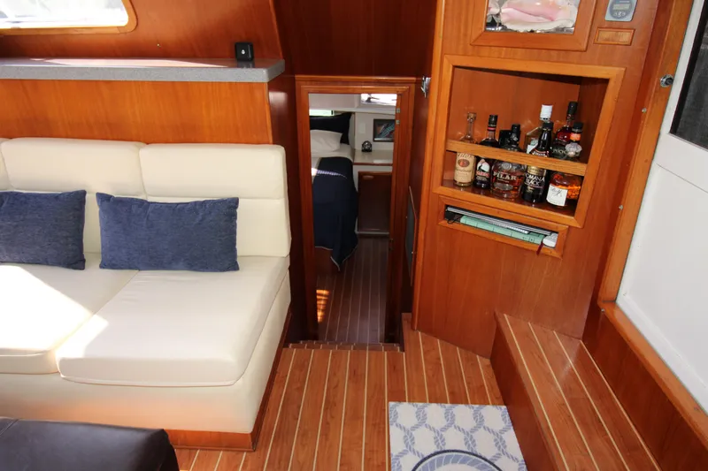 Gypsy Yacht Photos Pics Interior of 2000 Ricker 42 Classic yacht with cozy seating and wooden cabinetry.