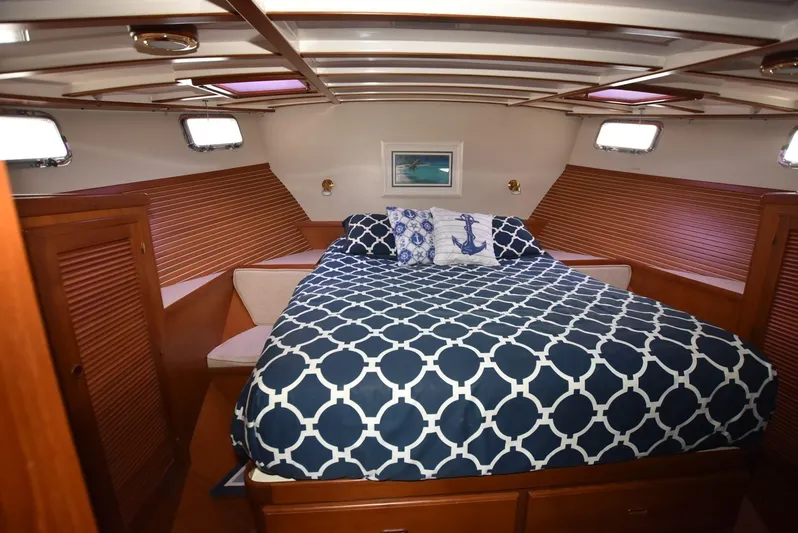 Almost Perfect Yacht Photos Pics 2006 Kadey-Krogen North Sea Widebody cabin with nautical-themed bedding and wooden interior.