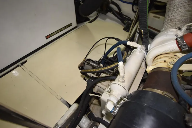 Almost Perfect Yacht Photos Pics Engine room of 2006 Kadey-Krogen North Sea Widebody, showcasing mechanical components and wiring.