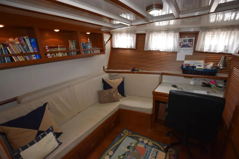 Almost Perfect Yacht Photos Pics 2006 Kadey-Krogen North Sea Widebody interior with cozy seating, bookshelves, and desk area.