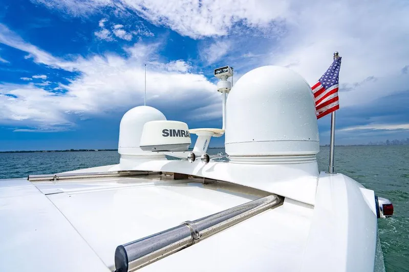 The Royal Blue Yacht Photos Pics Beneteau GRAN TURISMO 49 yacht, 2015 model, with radar and American flag on open water.
