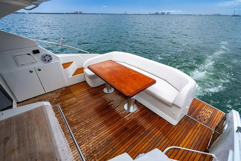 The Royal Blue Yacht Photos Pics Beneteau Gran Turismo 49 yacht deck with seating and table, 2015 model, on open water.