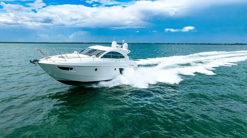 The Royal Blue Yacht Photos Pics 2015 Beneteau GRAN TURISMO 49 yacht cruising on open water under a blue sky.
