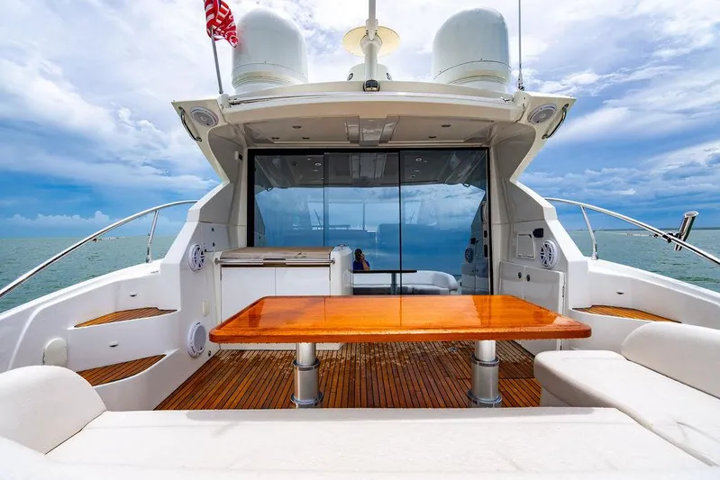 The Royal Blue Yacht Photos Pics Beneteau Gran Turismo 49 yacht deck with wooden table, ocean view, 2015 model.