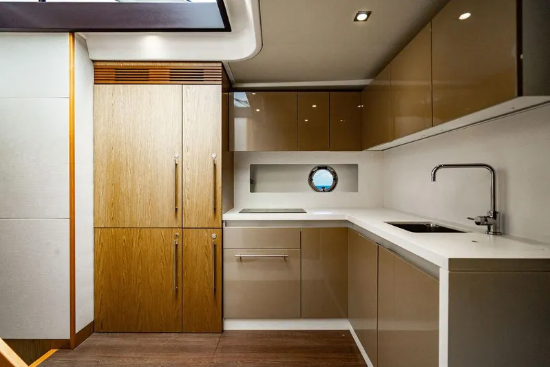 The Royal Blue Yacht Photos Pics Luxurious kitchen interior of 2015 Beneteau Gran Turismo 49 yacht, featuring modern cabinetry and fixtures.
