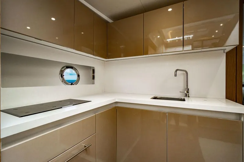 The Royal Blue Yacht Photos Pics Modern kitchen in 2015 Beneteau GRAN TURISMO 49 yacht with sleek cabinetry and porthole window.