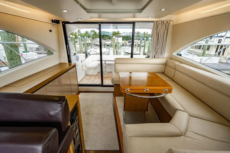 The Royal Blue Yacht Photos Pics Luxurious interior of 2015 Beneteau Gran Turismo 49 yacht with elegant seating and dining area.
