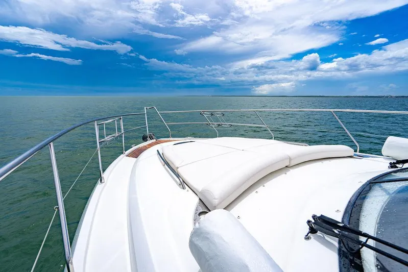 The Royal Blue Yacht Photos Pics Beneteau GRAN TURISMO 49 yacht, 2015 model, cruising on open sea under blue sky.
