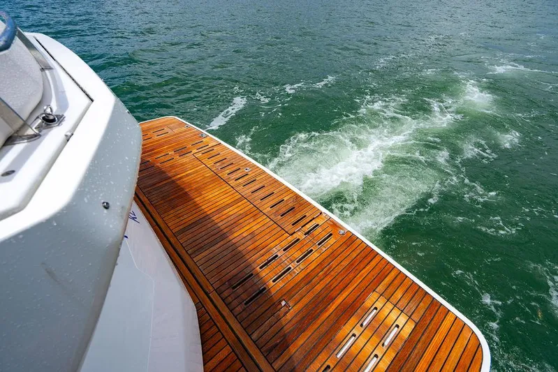 The Royal Blue Yacht Photos Pics Beneteau GRAN TURISMO 49 yacht, 2015 model, with teak swim platform on water.