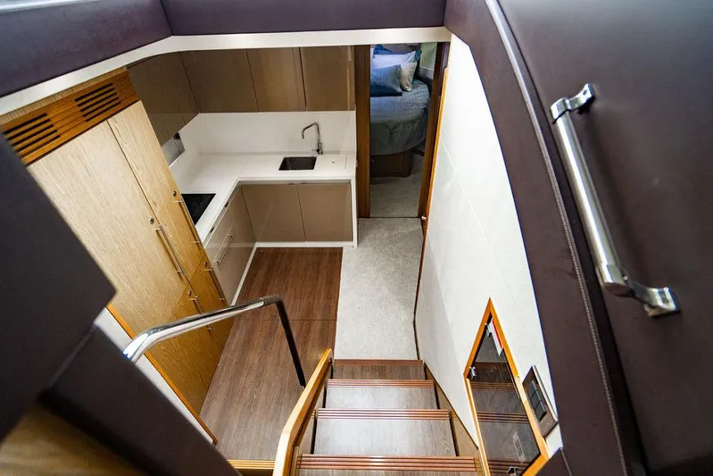The Royal Blue Yacht Photos Pics Interior view of 2015 Beneteau Gran Turismo 49 yacht, featuring modern kitchen and stairs.