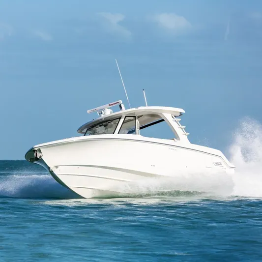  Yacht Photos Pics 2022 Boston Whaler 350 Realm cruising on open water, showcasing sleek design and performance.
