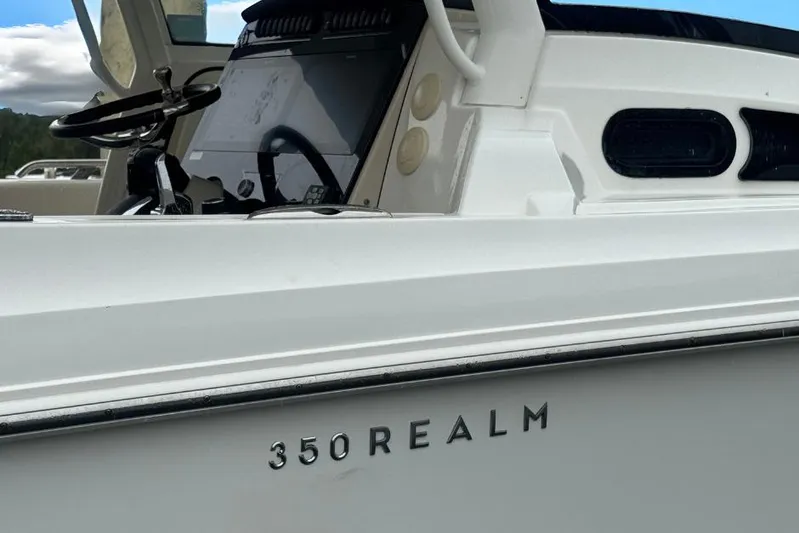  Yacht Photos Pics 2022 Boston Whaler 350 Realm boat, showcasing sleek design and modern helm controls.