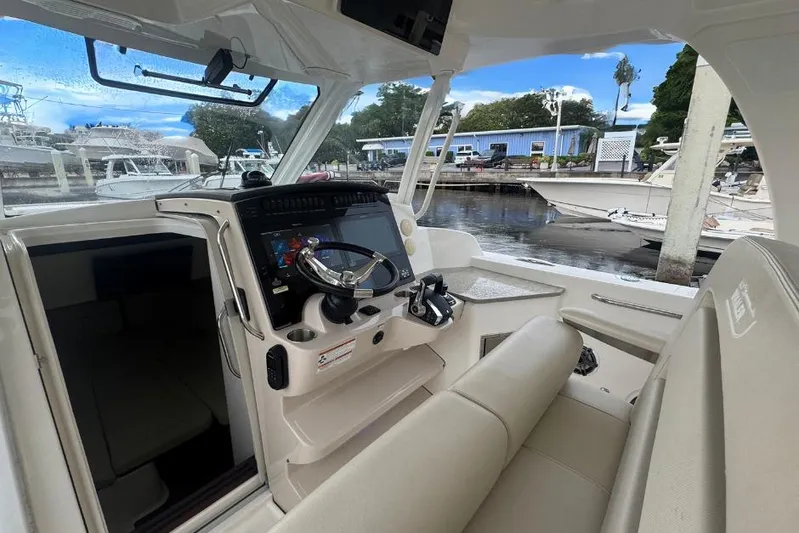  Yacht Photos Pics Interior view of 2022 Boston Whaler 350 Realm boat, featuring modern helm and seating.