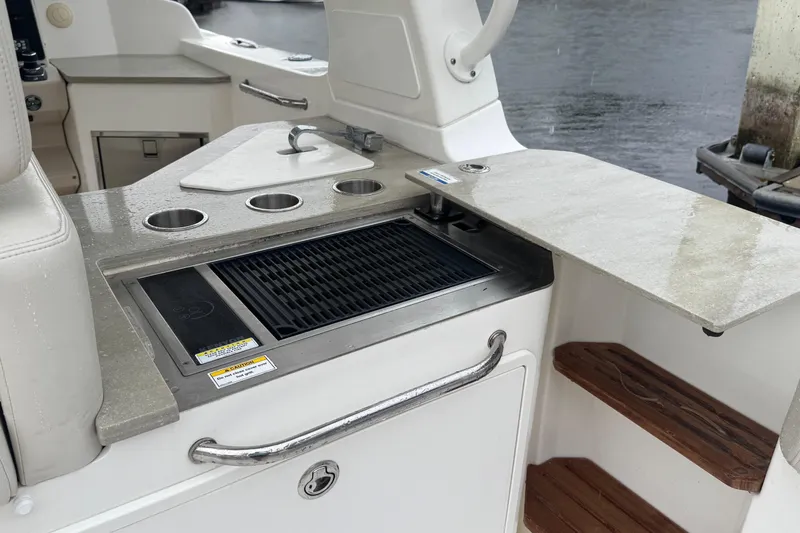  Yacht Photos Pics 2022 Boston Whaler 350 Realm boat with outdoor grill and sink setup.