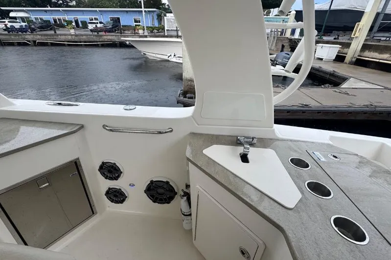  Yacht Photos Pics 2022 Boston Whaler 350 Realm interior with sink, storage, and speakers at dockside.